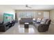 Well-lit living room with tile flooring, comfortable seating, and modern entertainment setup with large tv at 1440 S Keene Rd, Clearwater, FL 33756