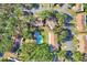 An aerial view shows a swimming pool nestled among residences and mature trees offering a private oasis at 1533 42Nd Avenue E Dr # 48, Ellenton, FL 34222