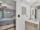 Main bedroom leading to bathroom featuring a stylish vanity and natural light at 1533 42Nd Avenue E Dr # 48, Ellenton, FL 34222