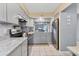 Modern kitchen with gray cabinets, stainless steel appliances, granite countertops, and tile flooring at 1533 42Nd Avenue E Dr # 48, Ellenton, FL 34222