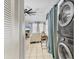 Inviting living room with ceiling fan, tile floors, a white sofa and a stacked washer and dryer at 1533 42Nd Avenue E Dr # 48, Ellenton, FL 34222