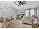 Open-concept living room with vaulted ceiling, fireplace, tile flooring, and modern furnishings at 1533 42Nd Avenue E Dr # 48, Ellenton, FL 34222