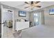 Bright main bedroom featuring neutral walls, a ceiling fan, and access to the attached bathroom at 1533 42Nd Avenue E Dr # 48, Ellenton, FL 34222