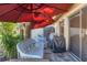 Relaxing patio has seating area and a gas grill, all shaded by a red patio umbrella at 1533 42Nd Avenue E Dr # 48, Ellenton, FL 34222