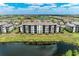 Beautiful aerial shot of a condo building with lush landscaping and surrounding lakes at 18028 Gawthrop Dr # 203, Bradenton, FL 34211