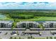 Scenic aerial view of condo community with golf course, lake and covered parking at 18028 Gawthrop Dr # 203, Bradenton, FL 34211
