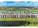 Beautiful aerial view of a condo community with a golf course and surrounding pond at 18028 Gawthrop Dr # 203, Bradenton, FL 34211