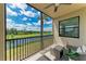 Relaxing screened balcony with seating and stunning views of the water and lush greenery at 18028 Gawthrop Dr # 203, Bradenton, FL 34211
