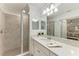 Bathroom with a glass enclosed shower, quartz countertop, and modern lighting at 18028 Gawthrop Dr # 203, Bradenton, FL 34211