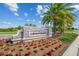 Stone sign welcomes you to Lakewood National, enhanced with beautiful landscaping, flowers, and palm trees at 18028 Gawthrop Dr # 203, Bradenton, FL 34211