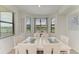 Dining room featuring a white table with seating for six and natural lighting from large windows at 18028 Gawthrop Dr # 203, Bradenton, FL 34211