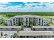 Stunning aerial view of a condo building with covered parking and lush landscaping at 18028 Gawthrop Dr # 203, Bradenton, FL 34211