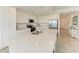 Spacious kitchen featuring stainless steel appliances, white cabinetry, and a quartz countertop island at 18028 Gawthrop Dr # 203, Bradenton, FL 34211
