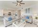 Bright living room featuring two grey sofas, a ceiling fan and an open floor plan to the kitchen at 18028 Gawthrop Dr # 203, Bradenton, FL 34211