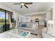 Bright living room featuring sliding doors to a balcony, with views into the adjacent kitchen at 18028 Gawthrop Dr # 203, Bradenton, FL 34211