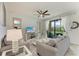 Bright living room with neutral decor, ceiling fan, and access to a balcony at 18028 Gawthrop Dr # 203, Bradenton, FL 34211