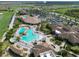 Aerial view of the community pool area with clubhouse, splashpad and outdoor seating at 18028 Gawthrop Dr # 406, Bradenton, FL 34211