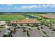 Aerial view showcasing the community clubhouse, putting green, water feature and golf course at 18028 Gawthrop Dr # 406, Bradenton, FL 34211