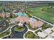 Aerial view of the community clubhouse, circular driveway, landscaping, and parking at 18028 Gawthrop Dr # 406, Bradenton, FL 34211