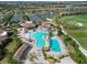 Aerial view of community pool, tennis courts, and clubhouse near the golf course at 18028 Gawthrop Dr # 406, Bradenton, FL 34211