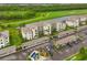 An aerial view showcasing the condo building, golf course, parking, and verdant greenery at 18028 Gawthrop Dr # 406, Bradenton, FL 34211