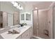 Bathroom with a double sink vanity, large mirror, and a glass-enclosed shower for a spa-like experience at 18028 Gawthrop Dr # 406, Bradenton, FL 34211