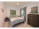 Well-lit bedroom featuring a stylish bed, modern decor, and a window with natural light at 18028 Gawthrop Dr # 406, Bradenton, FL 34211