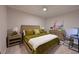 Bedroom features a woven headboard, olive green bedding, and a work desk for a relaxing space at 18028 Gawthrop Dr # 406, Bradenton, FL 34211