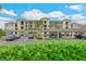 Exterior view of the condo building showcasing the well-maintained parking area and landscaping at 18028 Gawthrop Dr # 406, Bradenton, FL 34211