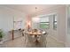 Elegant dining area with a round table, stylish chairs, and large windows offering scenic views at 18028 Gawthrop Dr # 406, Bradenton, FL 34211