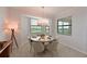 Cozy dining area featuring a round table, comfortable seating, and natural light from large windows at 18028 Gawthrop Dr # 406, Bradenton, FL 34211
