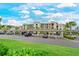 Well-maintained apartment building with covered parking and manicured green landscaping in a sunny setting at 18028 Gawthrop Dr # 406, Bradenton, FL 34211