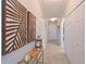 Welcoming hallway with decorative wood panels, neutral colors, and ample closet space for organized living at 18028 Gawthrop Dr # 406, Bradenton, FL 34211