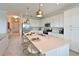 Modern kitchen with stainless steel appliances, white cabinetry, and a large island with seating at 18028 Gawthrop Dr # 406, Bradenton, FL 34211