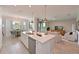 Spacious kitchen featuring a large island, stainless steel appliances, and adjacent dining and living areas at 18028 Gawthrop Dr # 406, Bradenton, FL 34211
