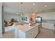 Open-concept kitchen with a large island, stainless steel appliances, and adjacent living area at 18028 Gawthrop Dr # 406, Bradenton, FL 34211