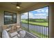 Enjoy the outdoors in this screened lanai with cozy seating overlooking scenic golf course and pond at 18028 Gawthrop Dr # 406, Bradenton, FL 34211