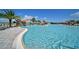 A sprawling community pool with plenty of lounge chairs and meticulously kept landscaping at 18028 Gawthrop Dr # 406, Bradenton, FL 34211