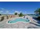 Accessible pool with a lift, surrounded by scenic landscaping and a clear blue sky at 18028 Gawthrop Dr # 406, Bradenton, FL 34211