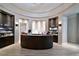 Elegant reception area with a curved desk, decorative shelves, and modern lighting at 18028 Gawthrop Dr # 406, Bradenton, FL 34211
