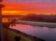 Beautiful sunset view over the water and golf course with vibrant orange and red colors at 18028 Gawthrop Dr # 406, Bradenton, FL 34211