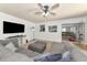 Open-concept living room featuring a large sectional sofa, ceiling fan, and entertainment center at 1808 25Th E Ave, Bradenton, FL 34208