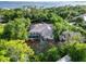 Aerial shot shows a home with a screened pool surrounded by lush foliage and nearby waterfront at 1860 Citron St, Punta Gorda, FL 33980