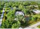 Drone's-eye view of a charming property surrounded by well-maintained landscaping and mature trees at 1860 Citron St, Punta Gorda, FL 33980