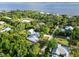 Scenic aerial view of a property surrounded by lush greenery, near a body of water, offering privacy and a serene setting at 1860 Citron St, Punta Gorda, FL 33980