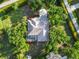 Aerial view of the house with a screened pool, surrounded by mature trees and lush greenery at 1860 Citron St, Punta Gorda, FL 33980