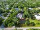 High angle view of a property featuring a screened pool, landscaping, and a private backyard surrounded by trees at 1860 Citron St, Punta Gorda, FL 33980