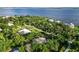 Aerial shot of a neighborhood featuring homes with pools and mature trees, located near a scenic waterfront at 1860 Citron St, Punta Gorda, FL 33980
