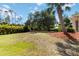 Expansive backyard featuring a well-manicured lawn and beautiful landscaping at 1860 Citron St, Punta Gorda, FL 33980