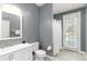 Modern bathroom with a white vanity, toilet, and a shower stall with glass doors at 1860 Citron St, Punta Gorda, FL 33980